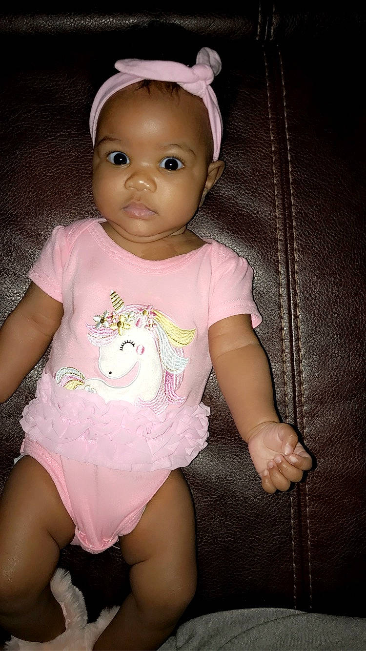 Bianca is registered to the contest to win money with this photo: baby, baby_products, baby_toddler_clothing, cheek, child, hair_accessory, hand, headband, headpiece, nightwear, person, pink, product, skin, sock, toddler