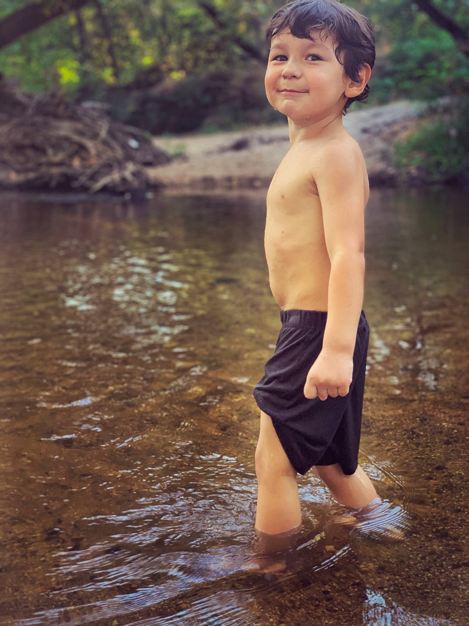 Gaige is registered to the contest to win money with this photo: bank, barechested, barefoot, child, fun, happy, joy, leg, male, muscle, people_in_nature, person, photography, play, river, smile, standing, stream, summer, toddler
