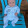 baby, blue_chair, brick_floor, calm, child, comfortable, cute, expression, face, feet, hands, indoor, infant, onesie, plastic_chair, portrait, sitting, white_clothing, wooden_wall, young_child