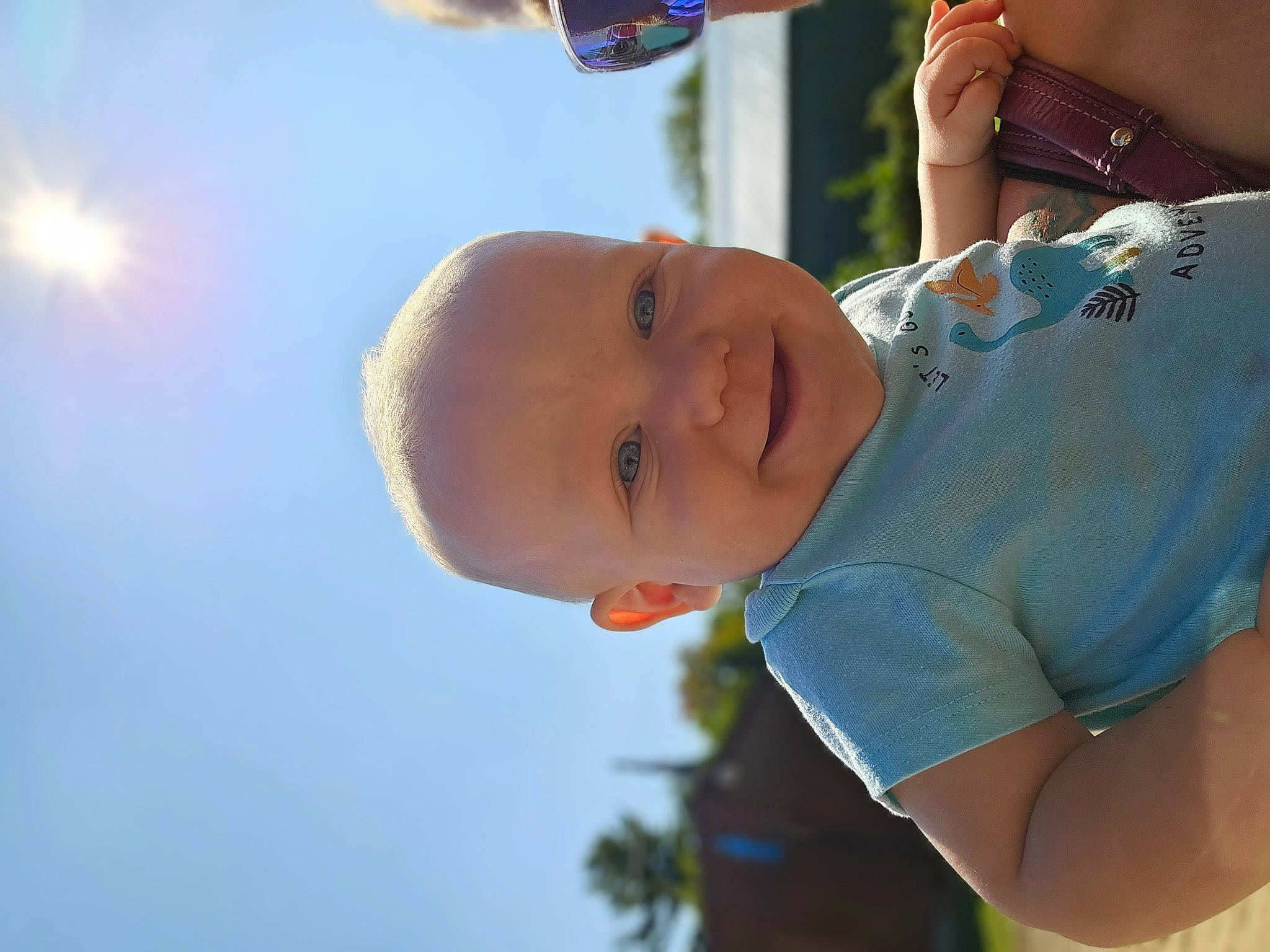 Jayden is registered to the contest to win money with this photo: baby, child, cloud, elbow, fun, gesture, grass, happy, hat, human_body, joy, leisure, people_in_nature, person, recreation, skin, sky, smile, sunlight, toddler