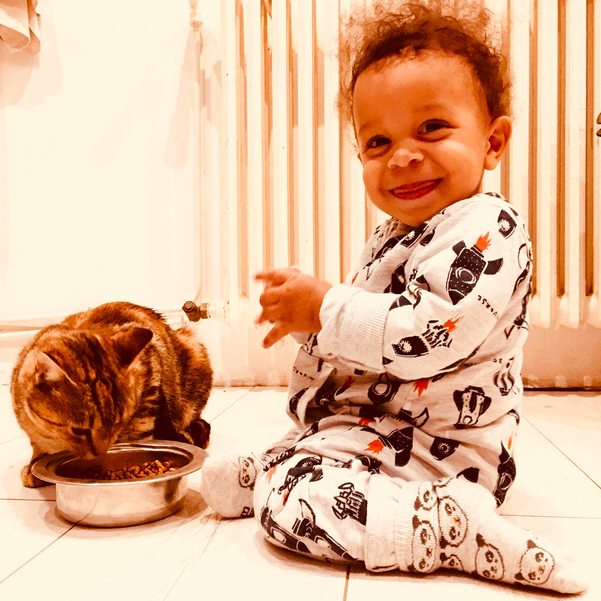 Lewis participe au concours pour gagner de l'argent avec cette photo : baby, baby_toddler_clothing, clothing, comfort, flooring, foot, hairstyle, happy, human_leg, joy, leg, outerwear, pattern, person, pottery, shoe, sleeve, smile, t_shirt, thigh