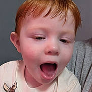 Michael is registered to the contest to win money with this photo: child, toddler, red_hair, face, open_mouth, shirt, cartoon_character, indoor, person, skin, expression, curious, cute, young, head, eye, clothing, portrait, human, baby