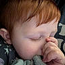 child, baby, red_hair, sleeping, thumb_sucking, blanket, close_up, face, peaceful, soft_texture, cute, resting, indoors, person, young_child, cozy, eyelashes, hand, skin, comfort