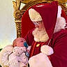 Michael joined the competition — help win amazing prizes! baby, pacifier, santa_claus, red_clothing, white_beard, glasses, throne, ornate_chair, holiday, christmas, festive, gloves, infant, sleeping, indoor, portrait, closeup, warm_lighting, decor, person