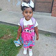 Maryleigh is registered to the contest to win money with this photo: child, girl, outdoor, sidewalk, backpack, curly_hair, white_bow, dress, cartoon_characters, sneakers, grass, concrete, building, door, handbag, toy, cute, portrait, standing, young