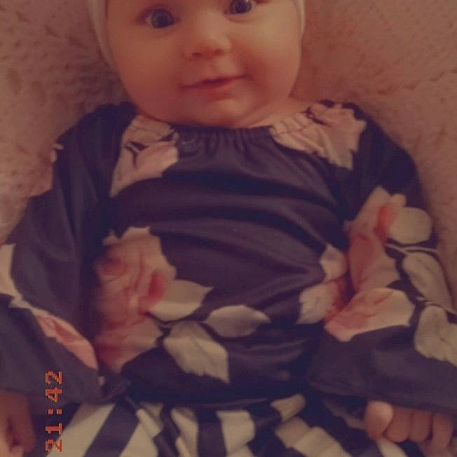 Adalynn is registered to the contest to win money with this photo: baby_toddler_clothing, dress, eye, eyelash, happy, head, headwear, human_body, iris, lip, mammal, mouth, neck, nose, outerwear, person, photograph, pink, skin, sleeve