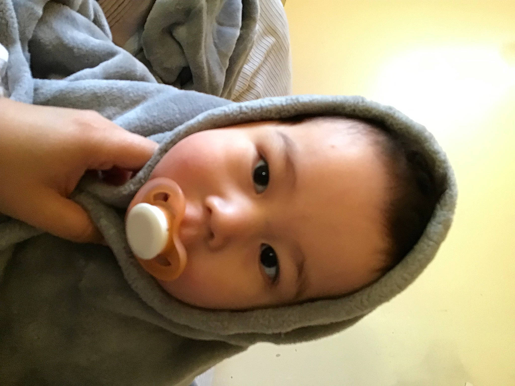Cade is registered to the contest to win money with this photo: baby, cheek, child, comfort, eye, eyelash, gesture, headgear, iris, jaw, lip, neck, no_expression, nose, person, skin, sleeve, smile, toddler, window