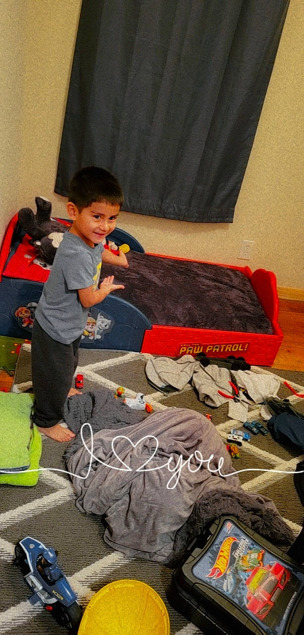 Sotero is registered to the contest to win money with this photo: audio_equipment, automotive_design, backpack, bag, baggage, boot, child, curtain, flooring, fun, games, joy, luggage_and_bags, person, play, recreation, room, shoe, sitting, sneakers