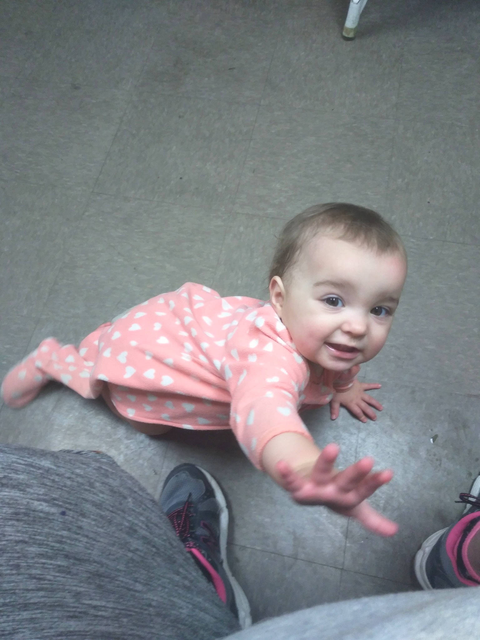 Maddy is registered to the contest to win money with this photo: arm, baby, baby_toddler_clothing, cheek, comfort, eye, finger, flash_photography, floor, flooring, head, iris, lip, nose, person, pink, shoulder, skin, smile, toddler