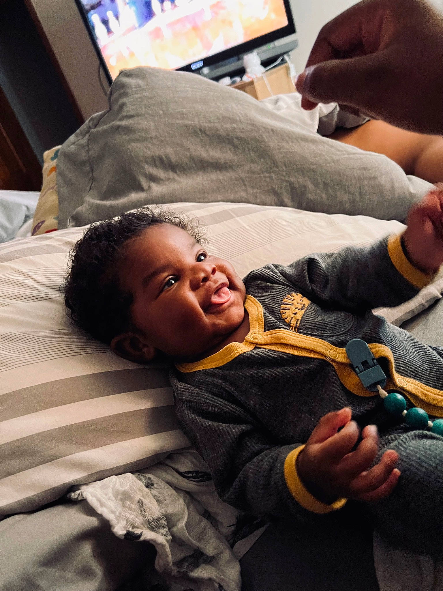 Nehemiah is registered to the contest to win money with this photo: child, comfort, cool, couch, elbow, finger, fun, gesture, hairstyle, hand, happy, human, nail, person, room, sitting, smile, thumb, vertebrate, wrist