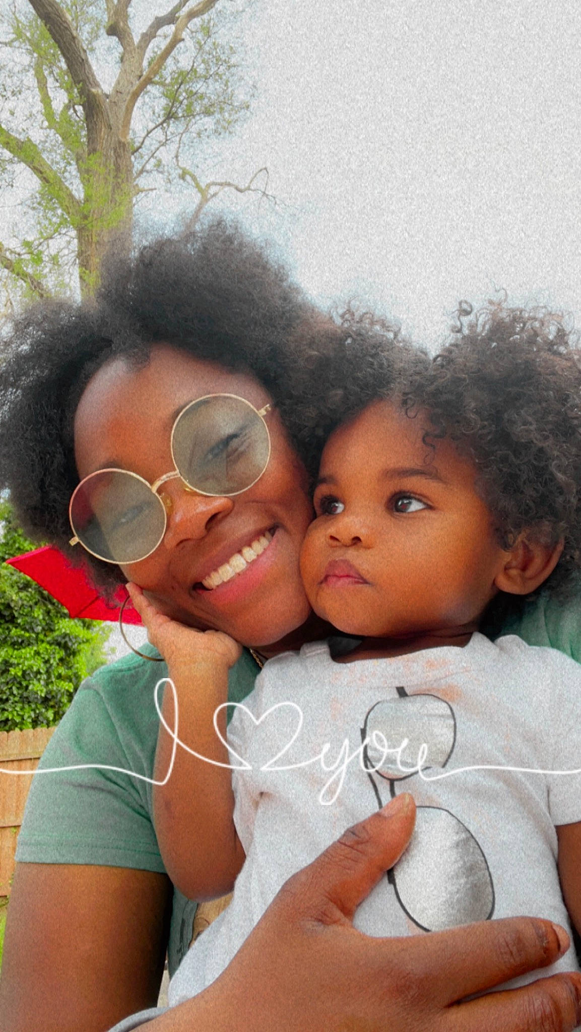 Nehemiah is registered to the contest to win money with this photo: cheek, chin, eye, eyelash, facial_expression, fun, gesture, happy, interaction, iris, joy, lip, mouth, nose, person, pink, plant, skin, smile, toddler