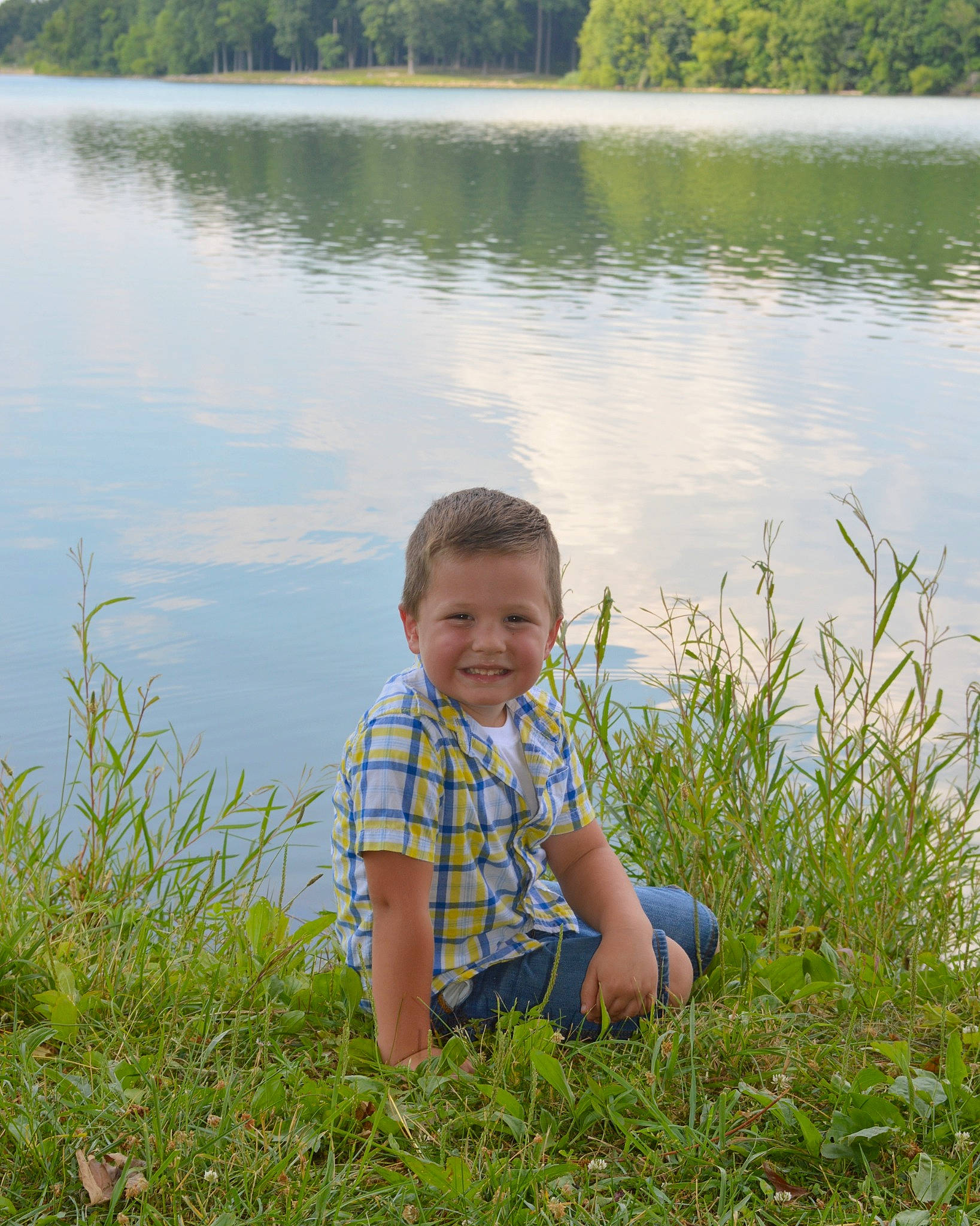 Logan Keith joined the competition — help win amazing prizes! bank, ecoregion, grass, green, happy, joy, lacustrine_plain, lake, landscape, leisure, natural_landscape, people_in_nature, person, plant, smile, summer, tree, vegetation, vertebrate, water