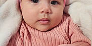 Raya joined the competition — help win amazing prizes! baby, child, pink_sweater, headband, bow, blanket, soft_texture, cute, portrait, indoor, infant, cozy, warm_clothing, hand, face, expression, young, adorable, close_up, curious
