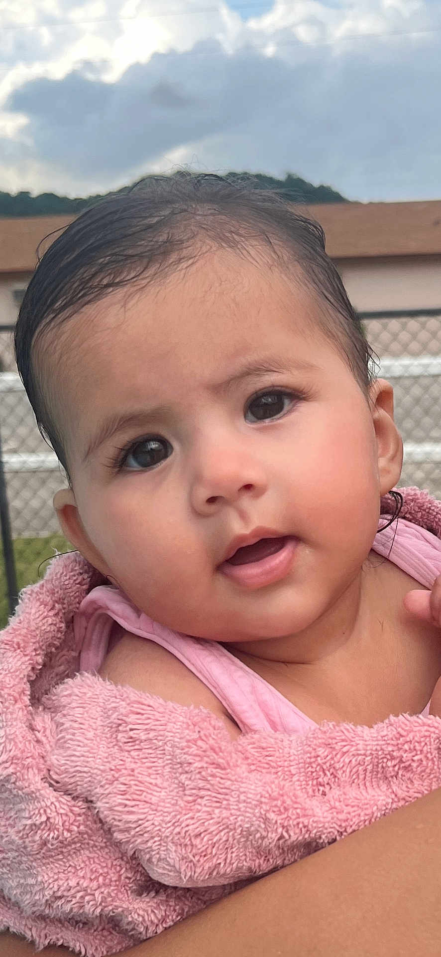 Raya joined the competition — help win amazing prizes! baby, child, face, pink_towel, outdoor, portrait, skin, expression, curly_hair, wet_hair, closeup, cute, infant, person, head, eyes, mouth, shoulder, nature, daylight
