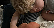 Tony is registered to the contest to win money with this photo: child, newborn, baby, sibling, sleeping, cuddling, family, portrait, indoors, blanket, clothing, blond_hair, infant, arms, face, bed, cozy, tender, resting, photography