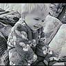 Tony joined the competition — help win amazing prizes! child, toddler, baby, portrait, sitting, smiling, happy, face, blond_hair, fuzzy_clothing, jacket, cushions, couch, blanket, indoors, home, black_and_white, grayscale, cozy, photography