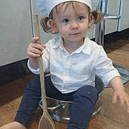 Shanna participe au concours pour gagner de l'argent avec cette photo : barefoot, blue_eyes, chef_hat, child, cooking, curious, cute, floor, fun, indoor, kitchen, navy_pants, playful, portrait, pot, sitting, toddler, white_shirt, wooden_spoon, young_child
