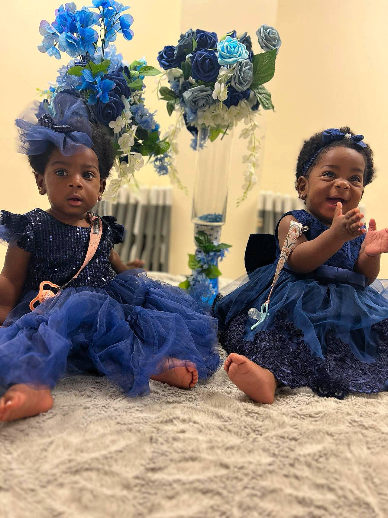 Faith is registered to the contest to win money with this photo: aqua, azure, barefoot, blue, child, electric_blue, event, flower, flower_arranging, fun, happy, headgear, leisure, people, people_in_nature, person, petal, plant, sitting, toddler