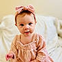 Josie is registered to the contest to win money with this photo: baby, child, girl, headband, bow, pink, dress, clothing, face, eyes, skin, hand, sitting, blanket, indoors, portrait, cute, infant, soft, young