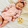 baby, infant, smiling, pink_dress, headband, blanket, milestone_sign, six_months, cute, happy, child, portrait, laying_down, indoor, soft_lighting, baby_girl, clothing, closeup, celebration, age_marker