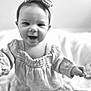 baby, child, smiling, headband, bow, black_and_white, portrait, happy, cute, infant, clothing, long_sleeves, person, closeup, indoors, soft_light, baby_girl, reaching_out, face, young_child