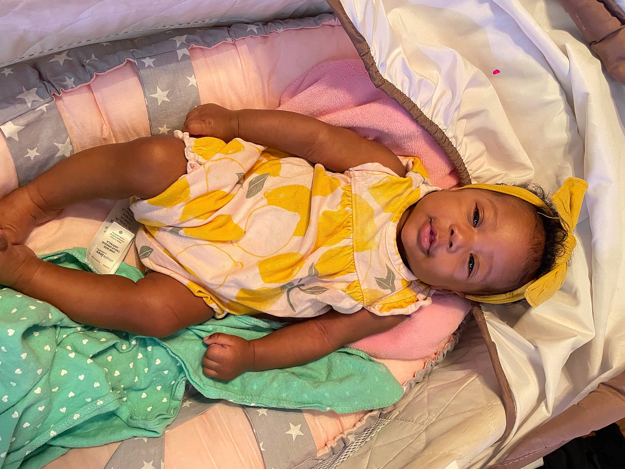 Kenzie joined the competition — help win amazing prizes! baby, baby_toddler_clothing, child, comfort, finger, fun, hairstyle, hand, happy, human_body, human_leg, lap, leg, linens, mammal, person, product, skin, textile, thigh