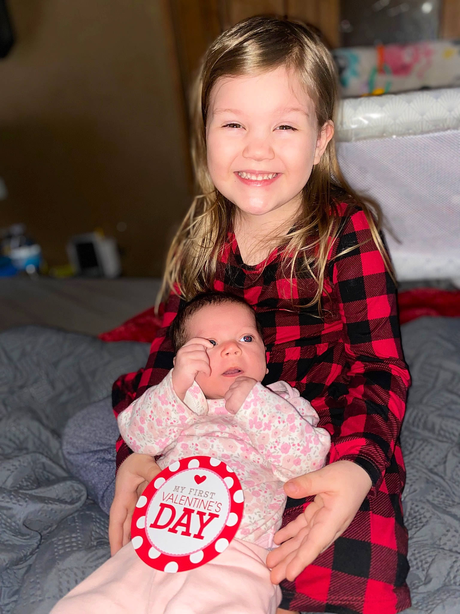 Aubriella is registered to the contest to win money with this photo: baby, baby_toddler_clothing, cheek, comfort, couch, eye, face, facial_expression, fun, hair, happy, head, human_body, joy, lap, person, plaid, red, skin, smile