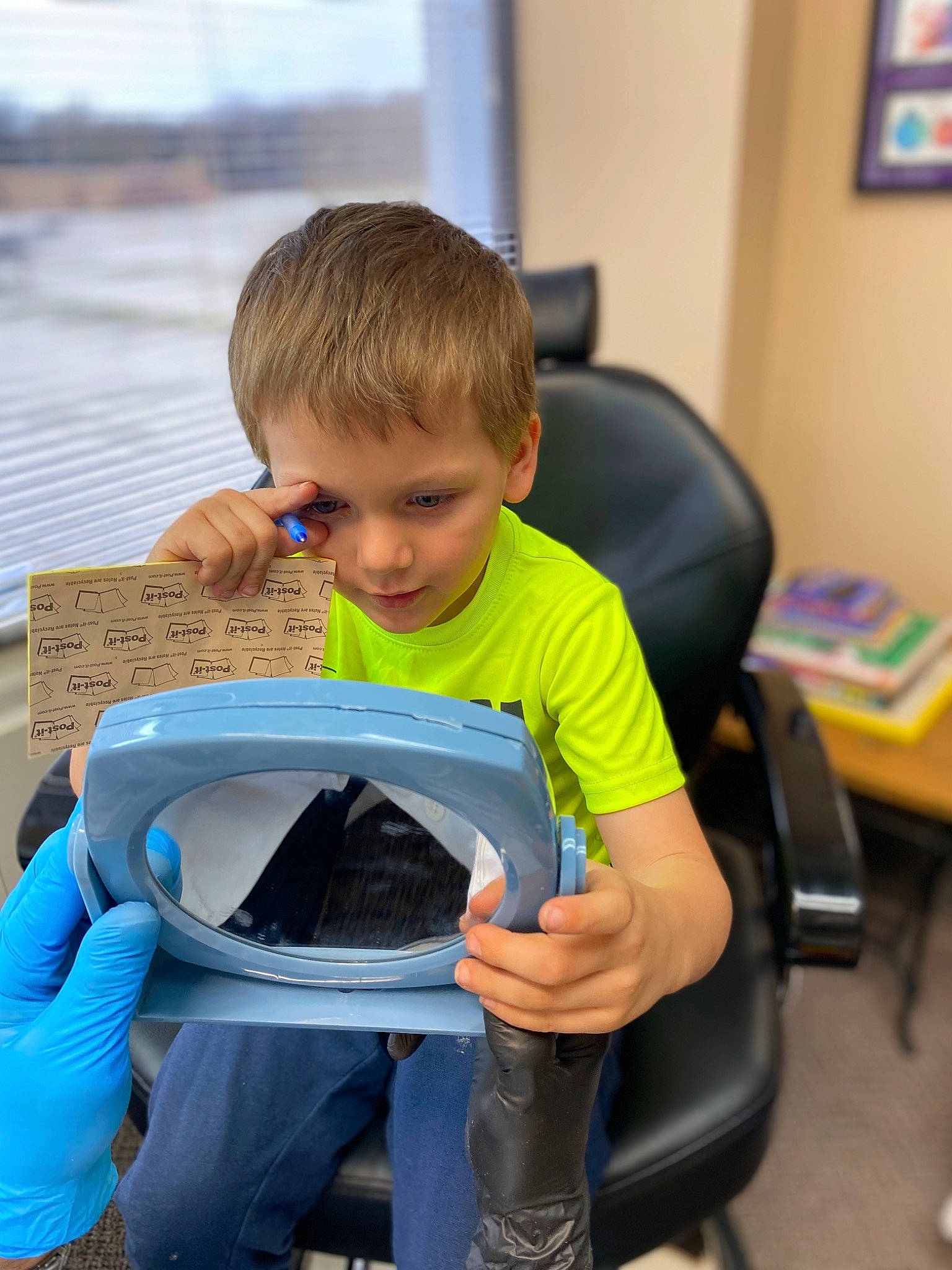 Kayjay is registered to the contest to win money with this photo: chair, child, face, fun, happy, lap, learning, leisure, person, personal_protective_equipment, picture_frame, play, reading, recreation, room, sharing, sitting, t_shirt, toddler, vacation