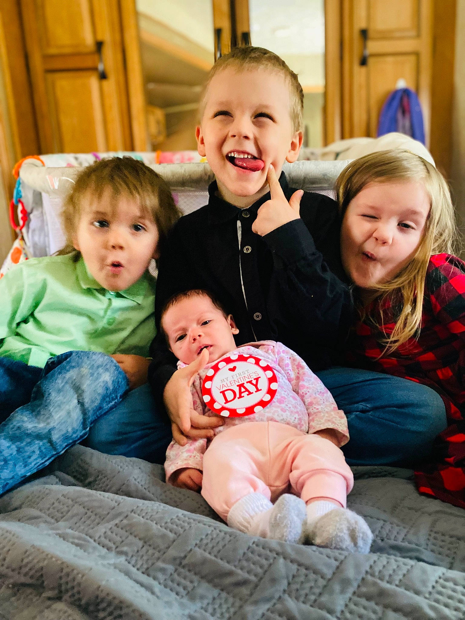 Kayjay is registered to the contest to win money with this photo: baby, baby_toddler_clothing, cheek, clothing, comfort, eye, face, fun, hairstyle, happy, head, human, human_body, interaction, iris, person, skin, smile, social_group, standing