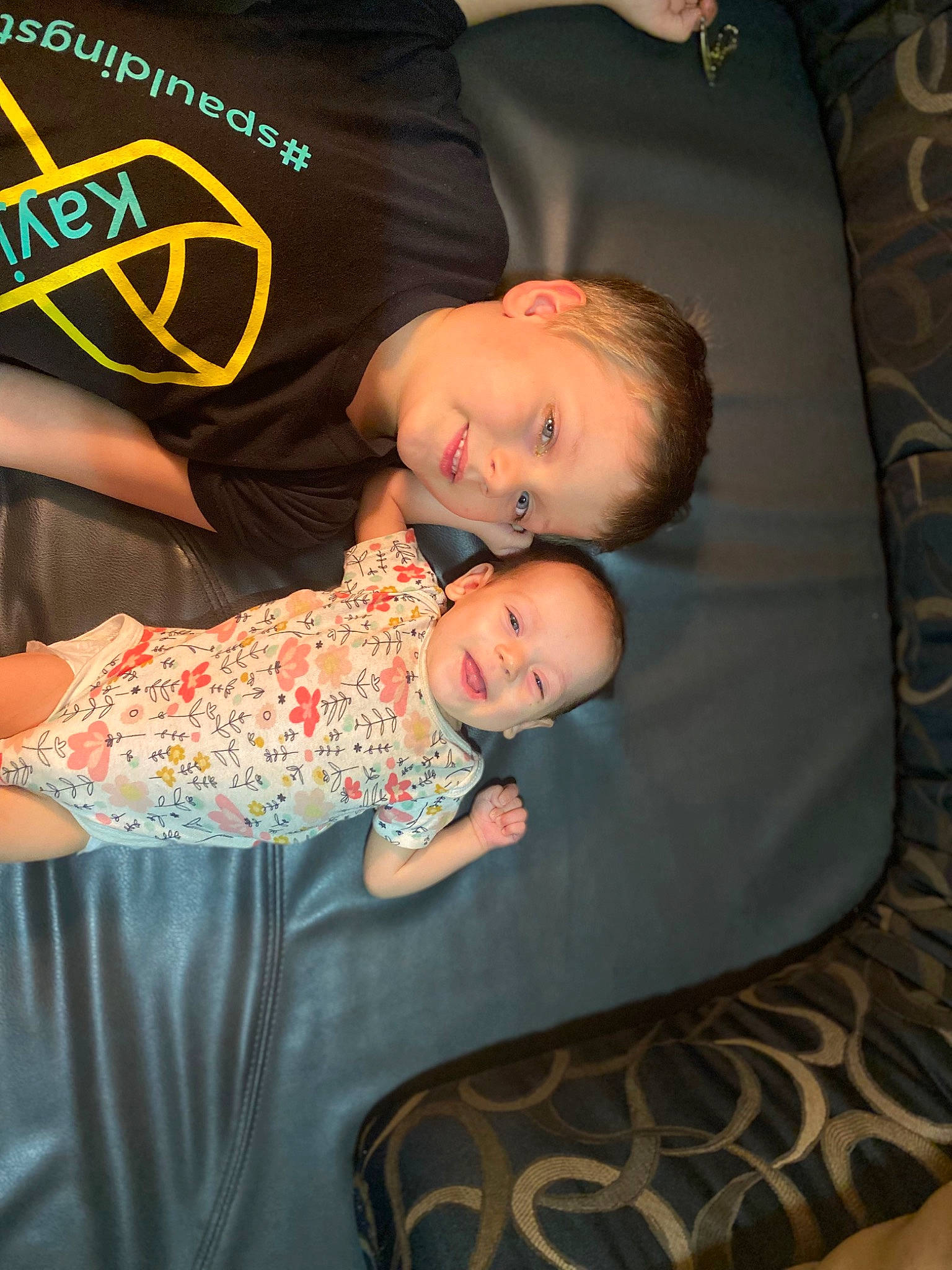 Kayjay is registered to the contest to win money with this photo: baby, baby_products, baby_toddler_clothing, child, comfort, couch, fun, happy, lap, leg, pattern, person, room, sitting, skin, sleeve, smile, t_shirt, textile, thigh