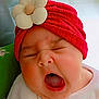 adorable, baby, child, closeup, cute, expression, face, flower_accessory, headwear, indoors, infant, mouth_open, newborn, person, portrait, red_turban, skin, sleepy, soft_clothing, yawning