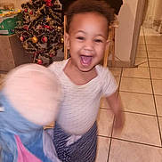 Joïa a rejoint le concours — aidez-le/la à gagner de superbes lots ! celebration, child, christmas_tree, clothing, festive, floor_tiles, furniture, happy, holiday, holiday_decor, home, indoor, joyful, motion_blur, person, plush_toy, room, smiling, toddler, toy