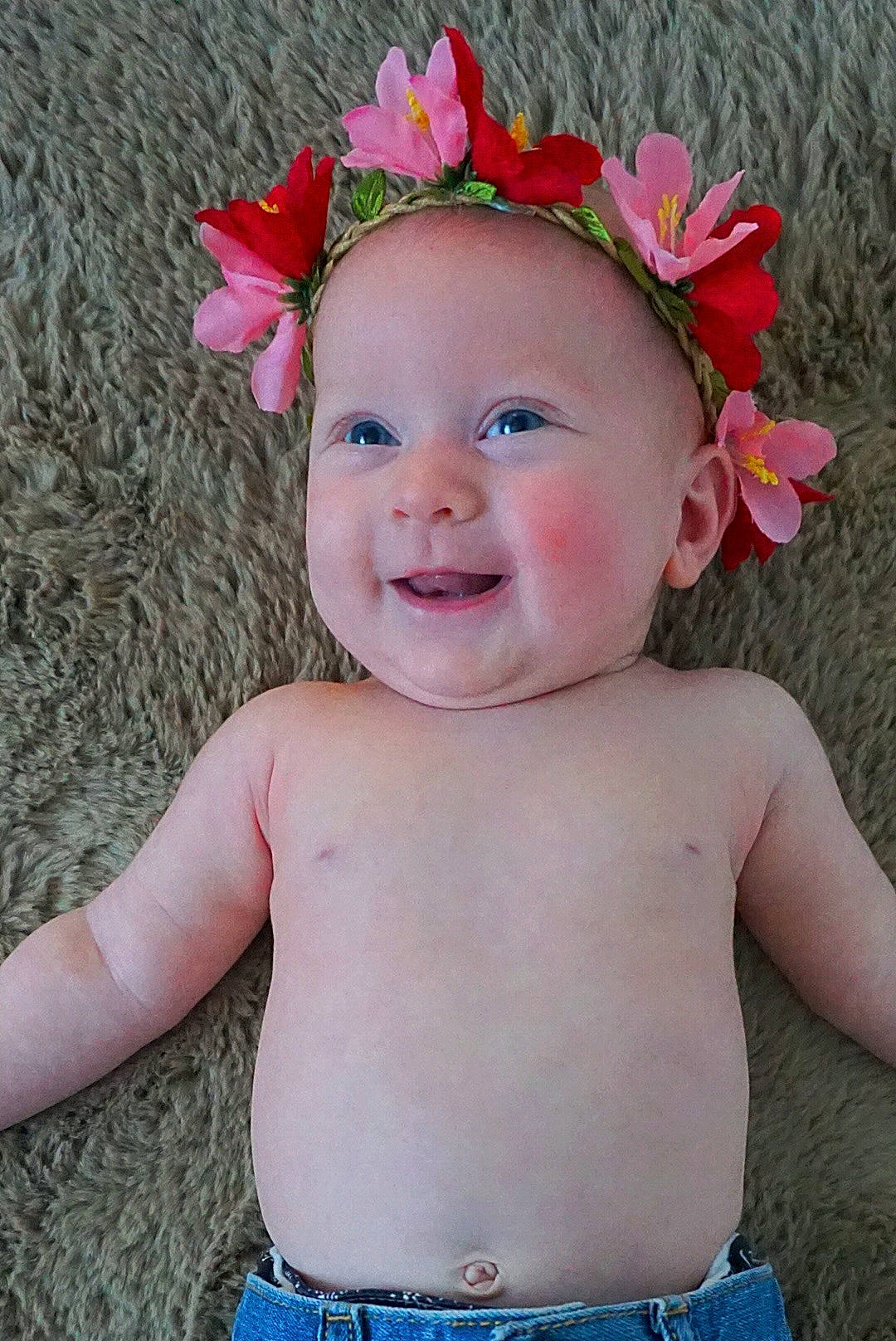 Nora is registered to the contest to win money with this photo: baby, baby_products, baby_toddler_clothing, cheek, child, face, fashion_accessory, flower, grass, hair_accessory, head, headband, headgear, headpiece, joy, person, photography, pink, plant, skin