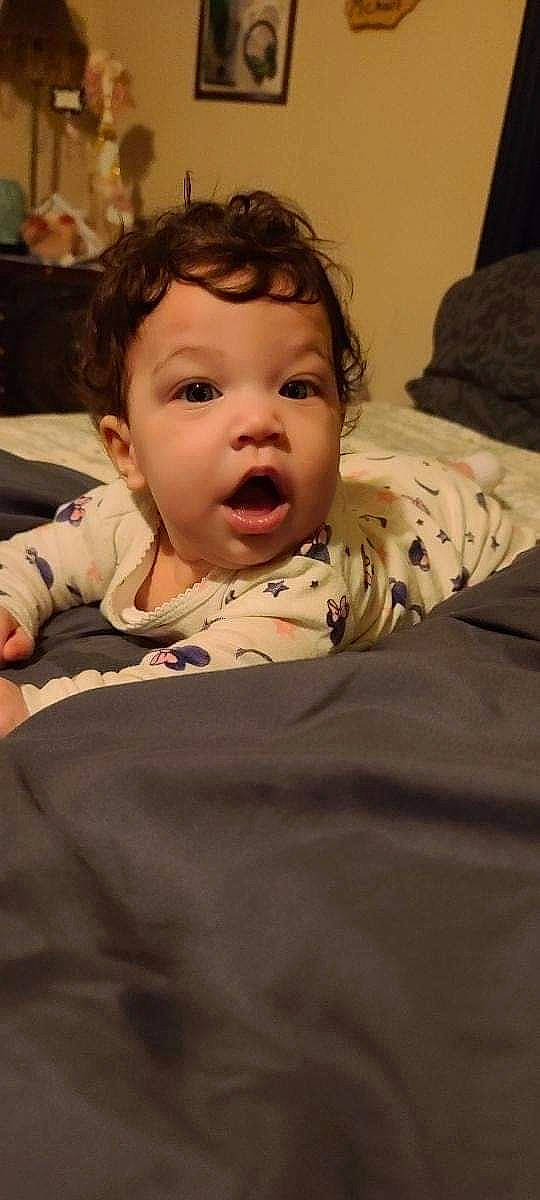 Karmen is registered to the contest to win money with this photo: baby, cheek, comfort, eye, eyebrow, face, floor, flooring, hair, happy, head, human_body, iris, lip, mouth, nose, person, skin, sleeve, surprise