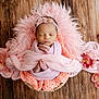 newborn, baby, sleeping, pink, blanket, basket, flower, headband, wooden_floor, cozy, soft, peaceful, infant, cute, portrait, wrapped, decorative, resting, child, toddler