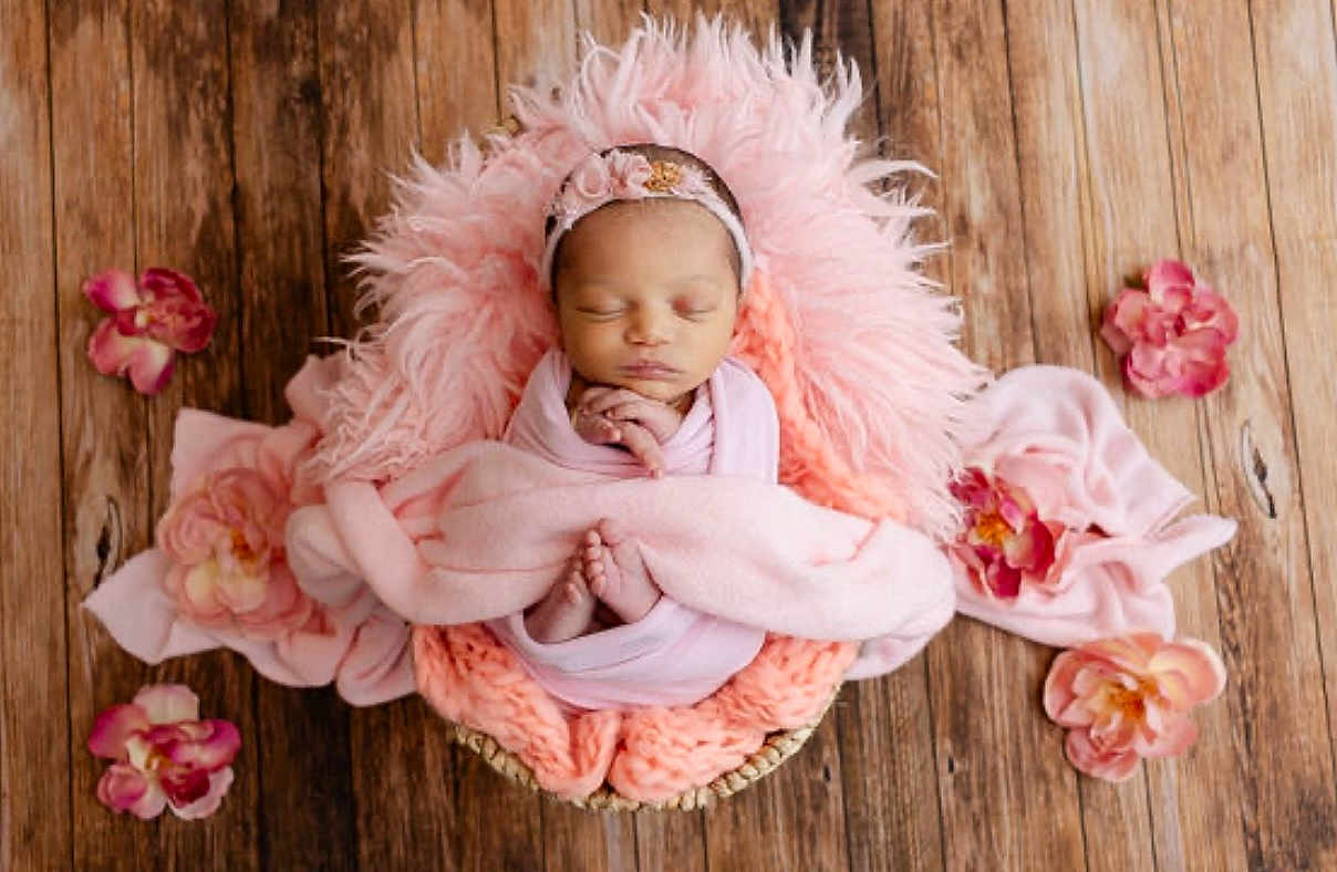 Kalayla Tapia is registered to the contest to win money with this photo: newborn, baby, sleeping, pink, blanket, basket, flower, headband, wooden_floor, cozy, soft, peaceful, infant, cute, portrait, wrapped, decorative, resting, child, toddler