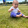 baby, child, grass, outdoor, park, person, tree, man, blue_vest, shorts, phone, sitting, clothing, foot, sky, clouds, nature, fence, bench, smile