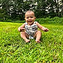 baby, grass, outdoor, smiling, child, greenery, nature, trees, sunlight, happy, sitting, infant, cute, portrait, one_person, young_child, casual_clothing, summer, daytime, barefoot