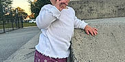 Mila is registered to the contest to win money with this photo: casual, child, clothing, concrete, curious, daylight, face, flowers, hand, outdoor, pavement, person, purple_pants, shoes, sky, standing, toddler, trees, urban, white_shirt