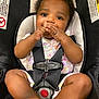 baby, child, car_seat, safety_harness, infant, cute, smiling, hands, feet, clothing, patterned_outfit, black_straps, indoors, seat, young_child, portrait, happy, skin, face, close_up