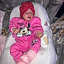baby, infant, newborn, sleeping, pink_clothing, minnie_mouse, hat, turban, knitted_socks, onesie, bedding, lounger, cozy, portrait, indoor, closed_eyes, peaceful, cute, headwear, small_hands
