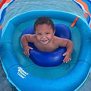 Lennox is registered to the contest to win money with this photo: toddler, child, inflatable, pool, water, float, canopy, swimming, smiling, happy, summer, outdoor, baby, fun, play, blue, orange, skin, face, person