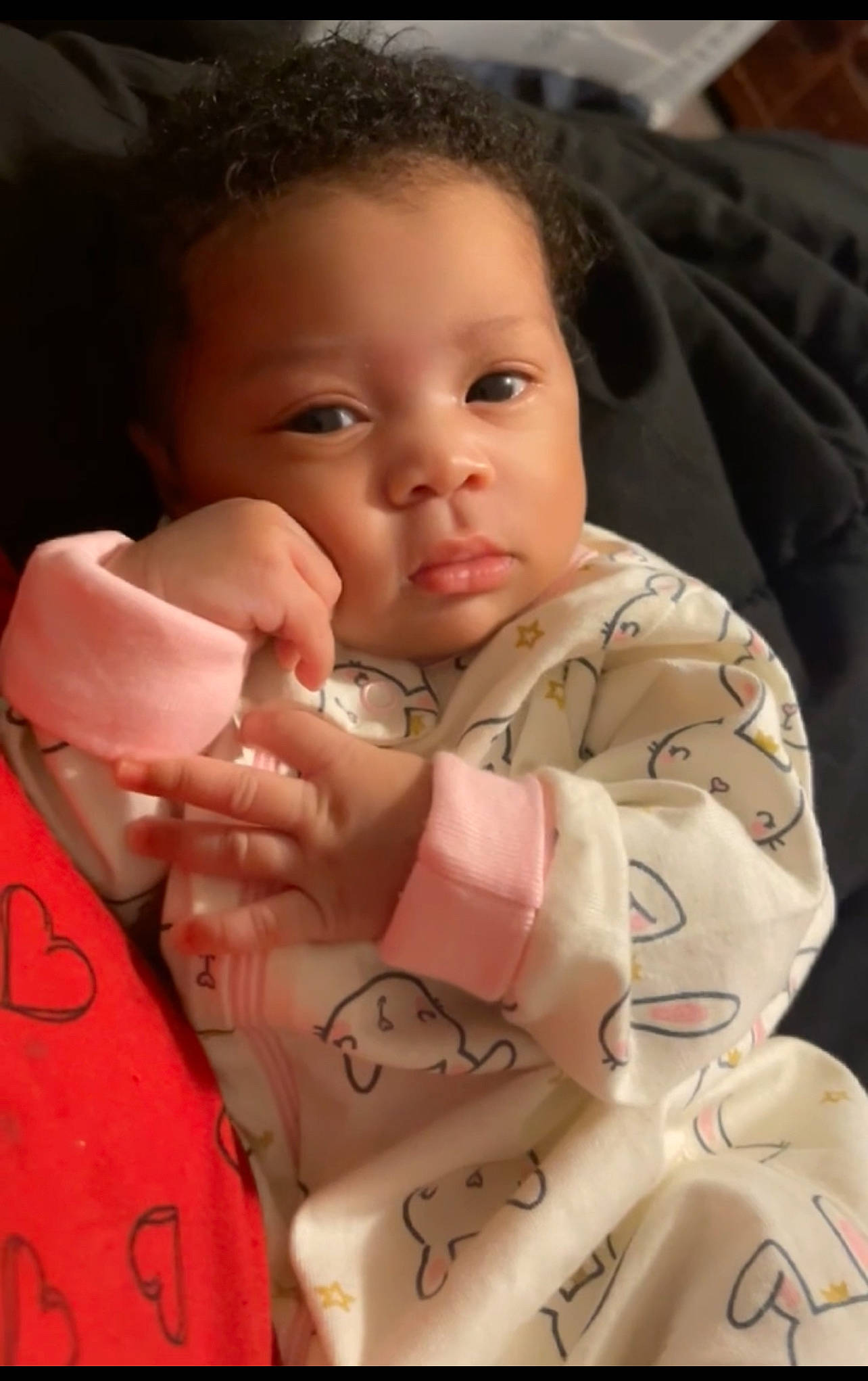 Zacaria is registered to the contest to win money with this photo: baby, baby_toddler_clothing, carmine, cheek, child, comfort, eyelash, facial_expression, finger, gesture, hand, happy, linens, lip, mouth, nail, nose, person, skin, thumb