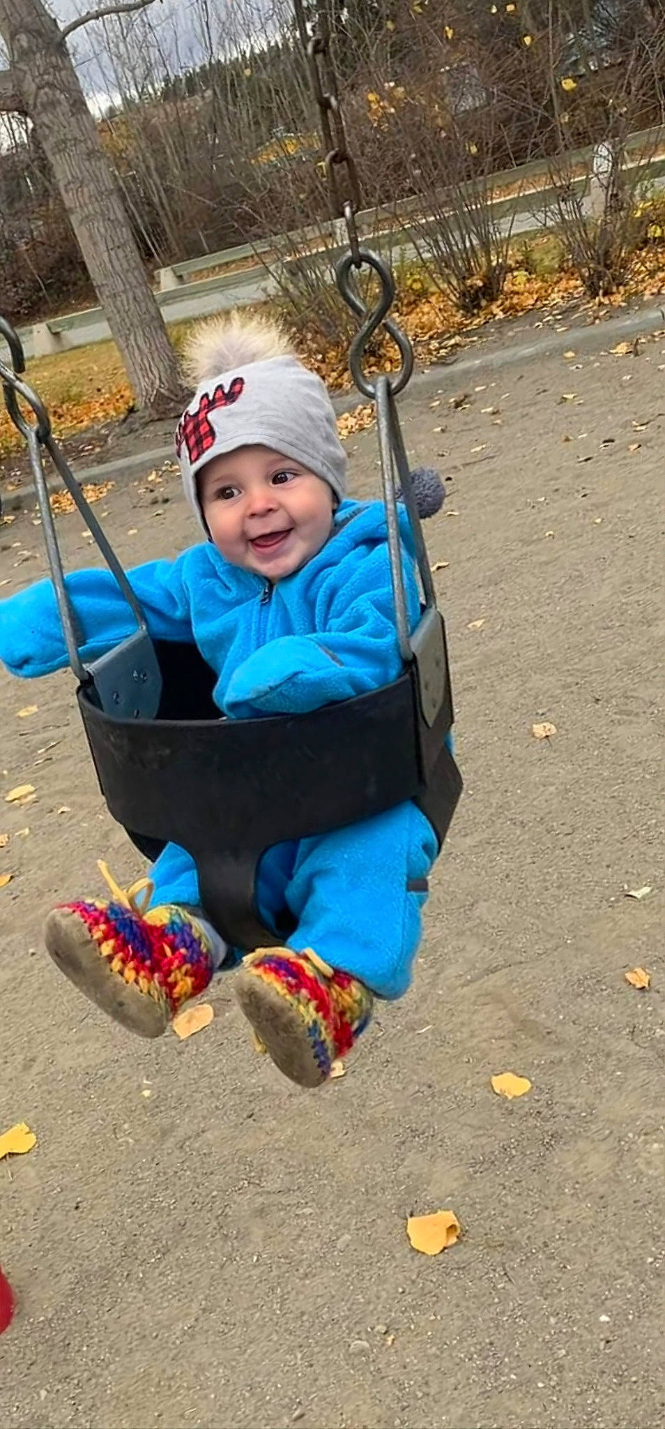 Easton is registered to the contest to win money with this photo: baby, baby_products, baby_toddler_clothing, child, city, electric_blue, fun, grass, headwear, joy, leaf, leisure, outdoor_play_equipment, people_in_nature, person, plant, playground, recreation, sitting, smile