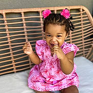 Shanaëlle participe au concours pour gagner de l'argent avec cette photo : toddler, child, pink_dress, hair_accessories, smiling, sitting, bench, cushion, indoor, cute, happy, person, portrait, playful, baby, hand, face, clothing, skin, hair