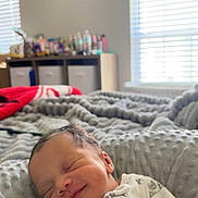 Elijah joined the competition — help win amazing prizes! newborn, baby, smiling, blanket, bed, indoors, cozy, sleeping, soft, pacifier, window, light, face, person, infant, clothing, quiet, peaceful, resting, nursery