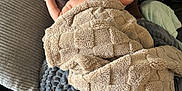 Elijah is registered to the contest to win money with this photo: baby, sleeping, blanket, couch, person, adult, brown_clothing, cozy, indoor, comfort, soft_texture, relaxation, head, arm, pillow, fabric, home, rest, infant, peaceful