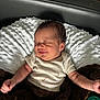 baby, blanket, child, clothing, comfort, cozy, cute, human, indoors, infant, lying_down, newborn, peaceful, pillow, portrait, resting, sleeping, smiling, soft_texture, toddler