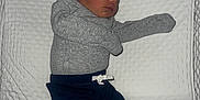 Elijah is registered to the contest to win money with this photo: baby, blanket, blue_pants, child, cute, gray_clothing, hat, indoors, infant, lying_down, newborn, peaceful, person, portrait, rest, sleep, sleeping, small, soft_surface, white_socks