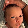 Elijah is registered to the contest to win money with this photo: baby, care, closeup, clothing, curious, cute, expression, eyes, face, hand, head, human, infant, newborn, person, portrait, protection, skin, sleepwear, soft